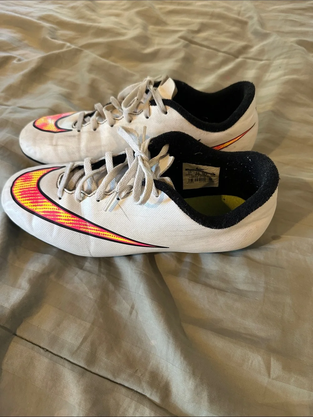 Nike Kids White Soccer Cleats with Neon Yellow and Pink Swoosh